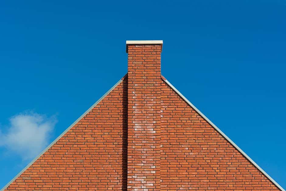 Professional chimney sweep removing creosote from a chimney